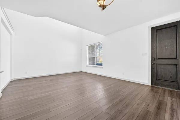 a view of a kitchen with a sink and wooden floor