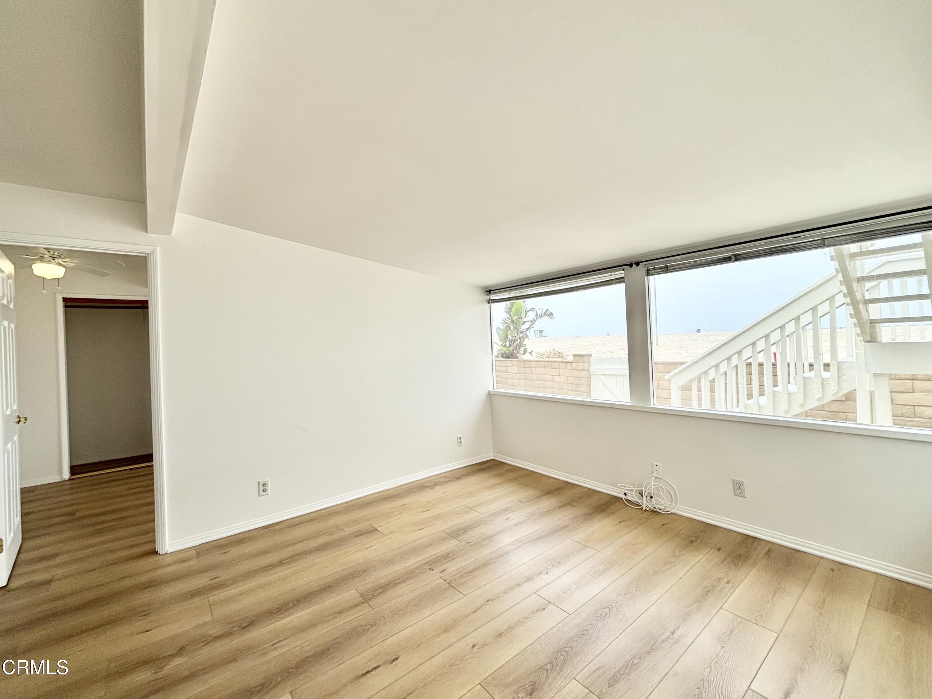4029 Ocean Drive Oxnard, CA 93035 - Photo 17 of 20 a view of an empty room with wooden floor and a window