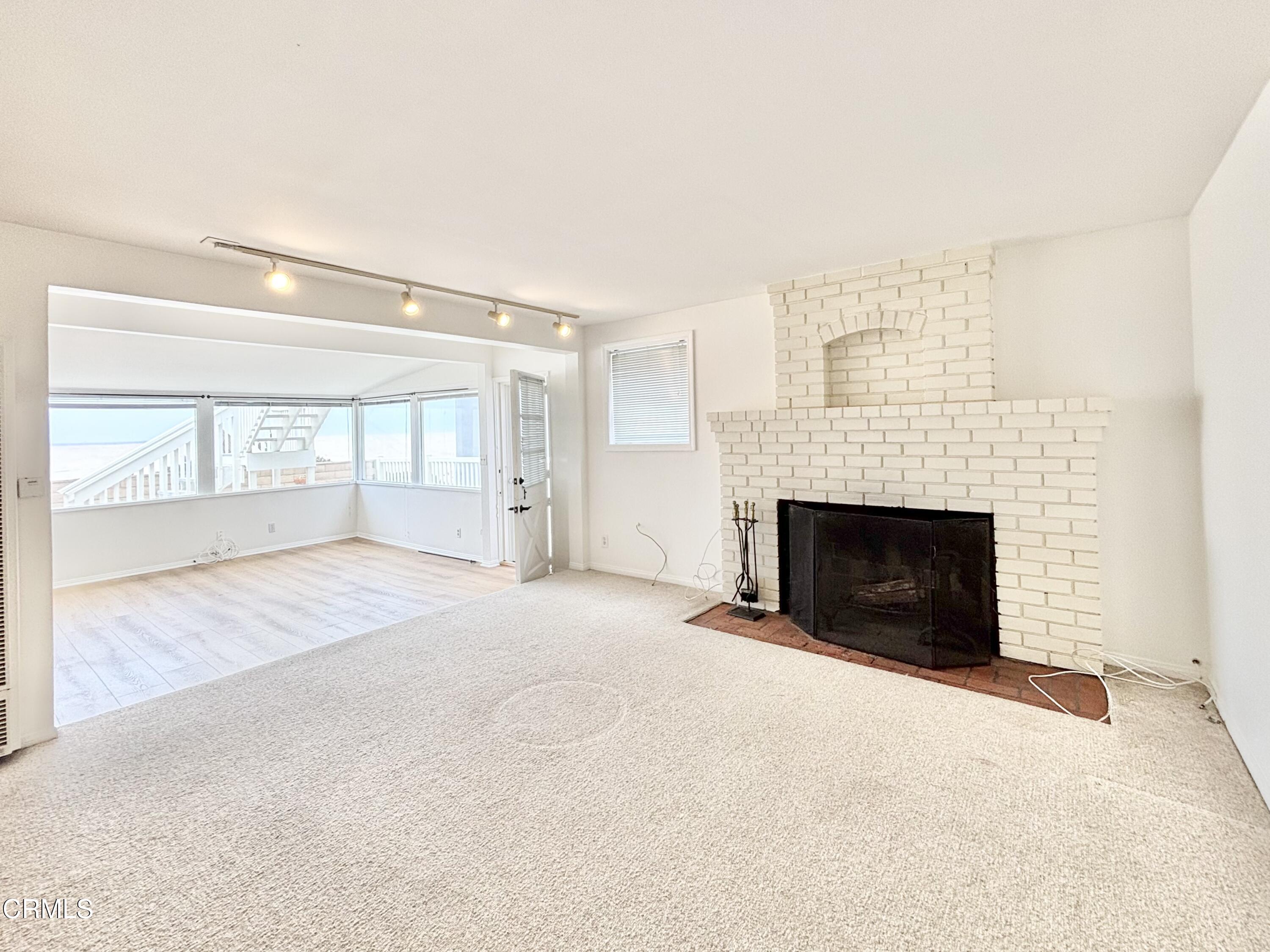 4029 Ocean Drive Oxnard, CA 93035 - Photo 2 of 20 a view of an empty room with a fireplace and a window