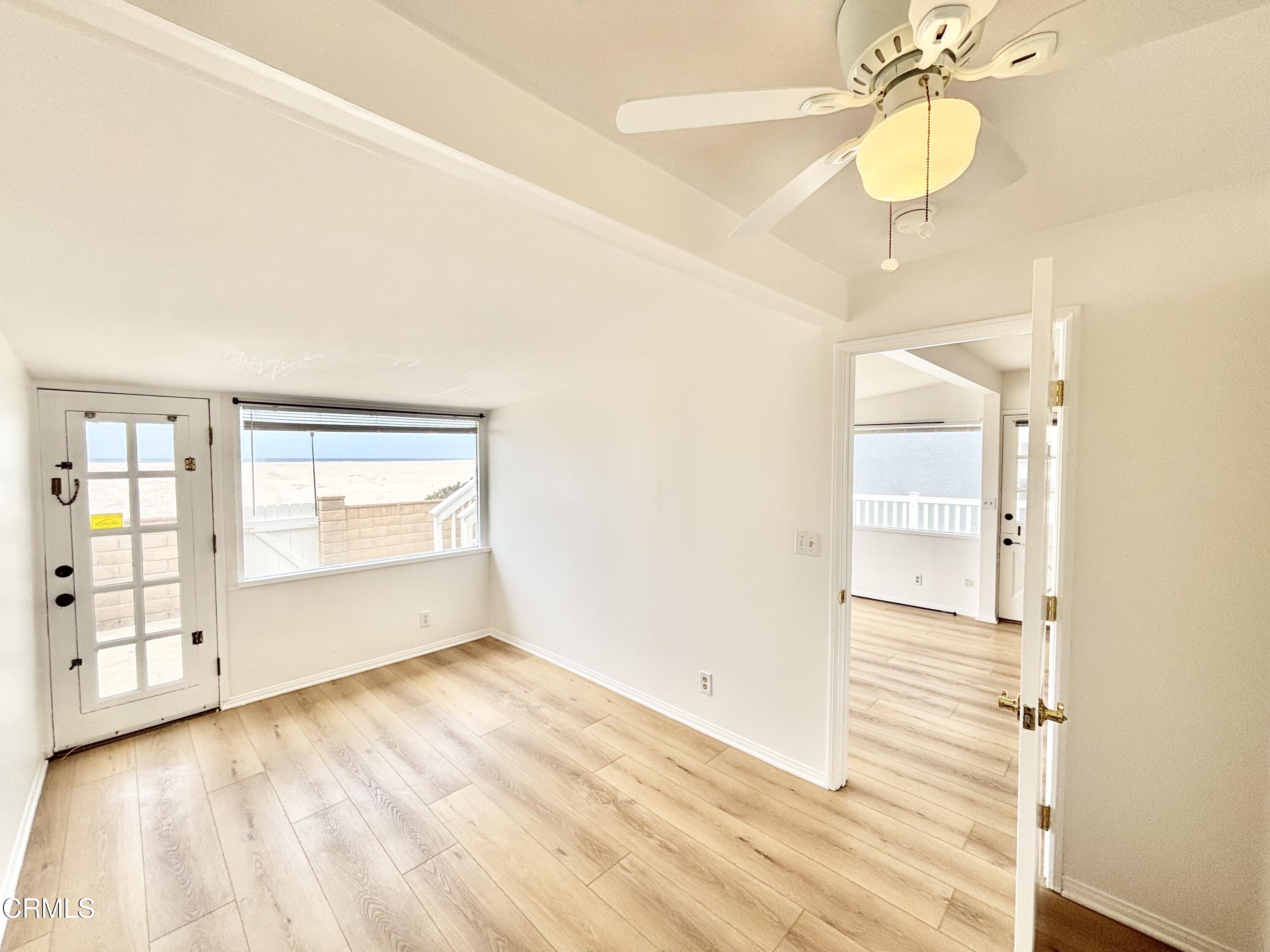 4029 Ocean Drive Oxnard, CA 93035 - Photo 4 of 20 a view of empty room with wooden floor and fan