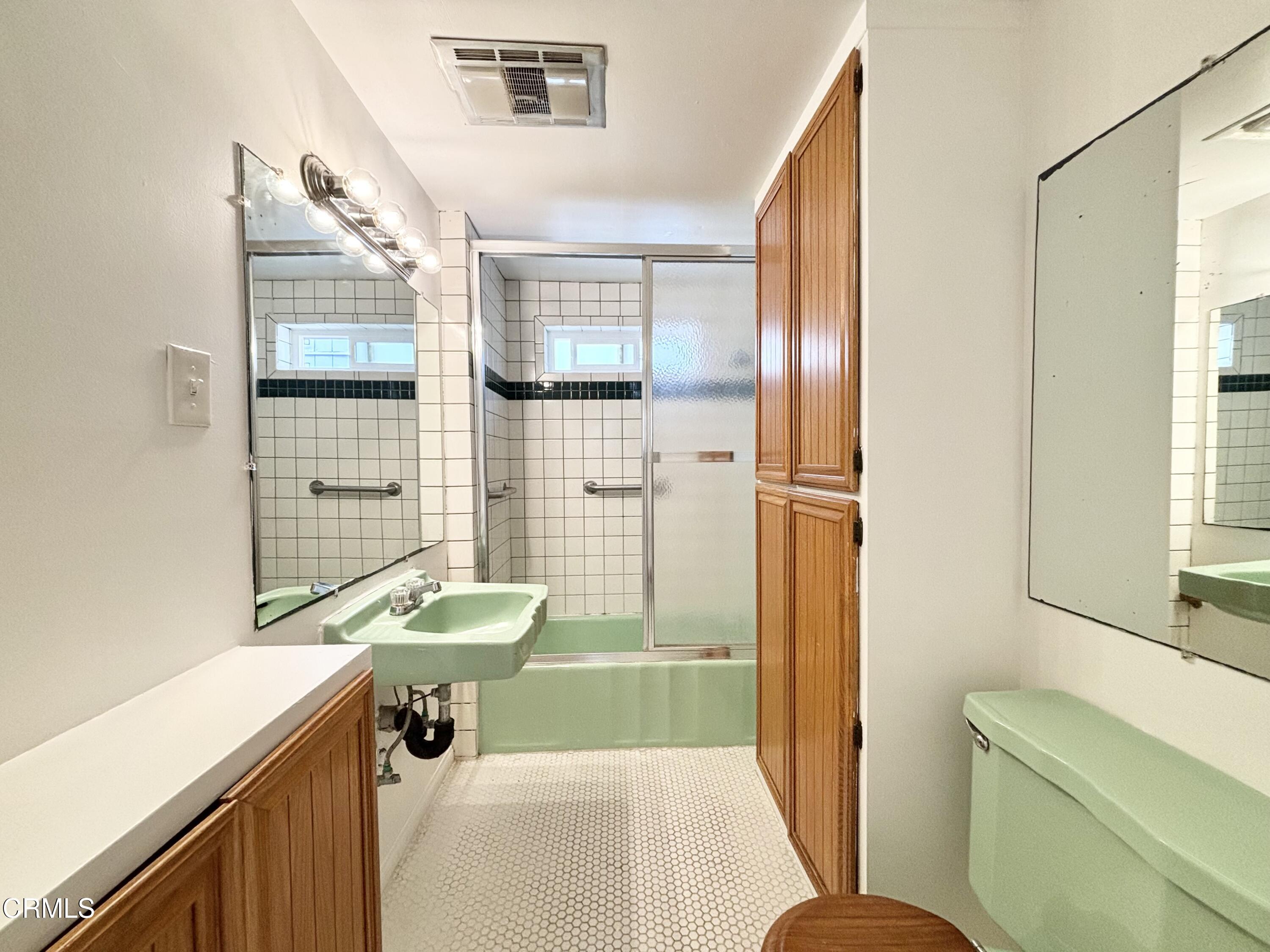 4029 Ocean Drive Oxnard, CA 93035 - Photo 7 of 20 a bathroom with a sink toilet a mirror and shower