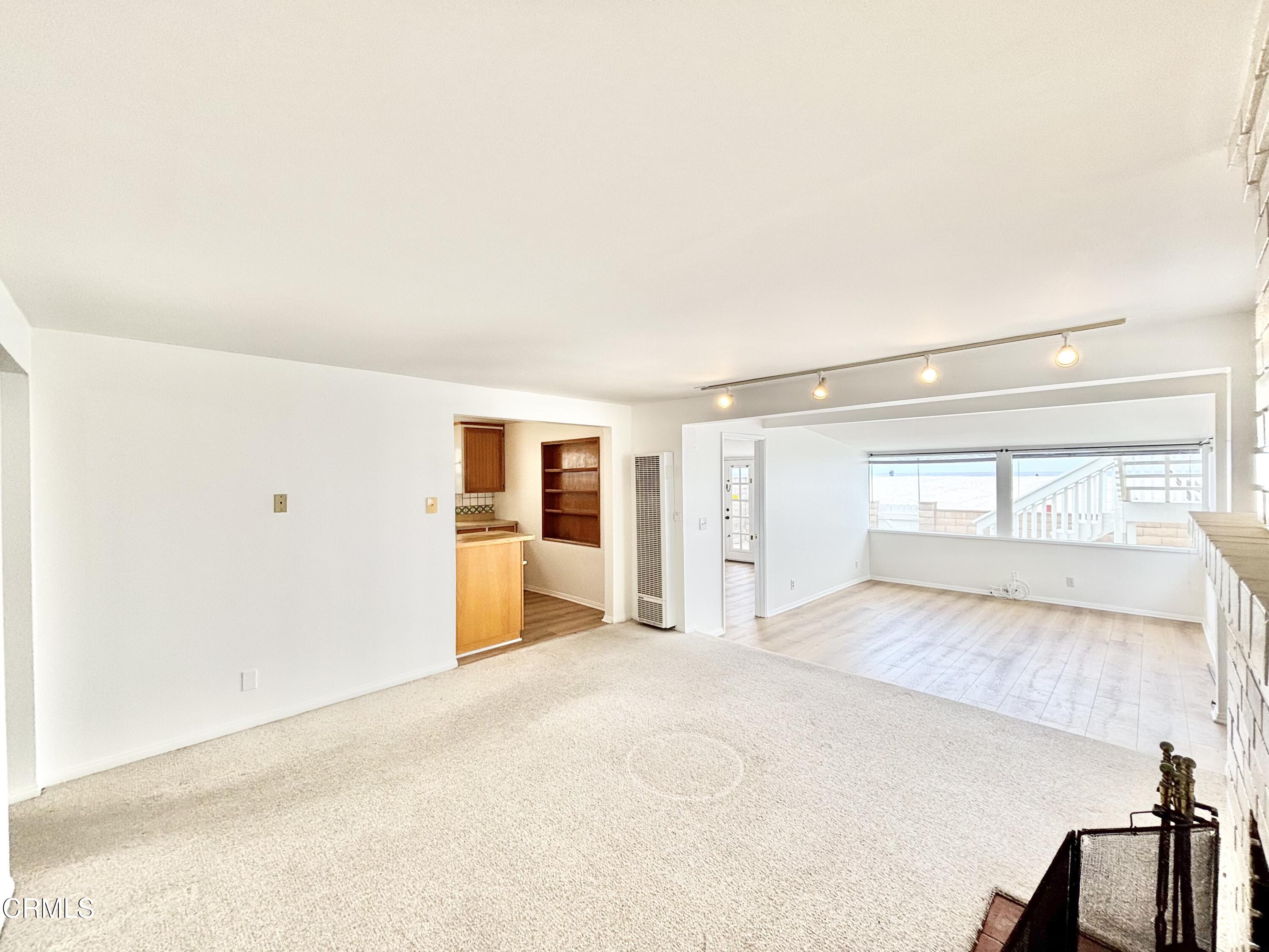 4029 Ocean Drive Oxnard, CA 93035 - Photo 9 of 20 a view of a livingroom with wooden floor and a large window