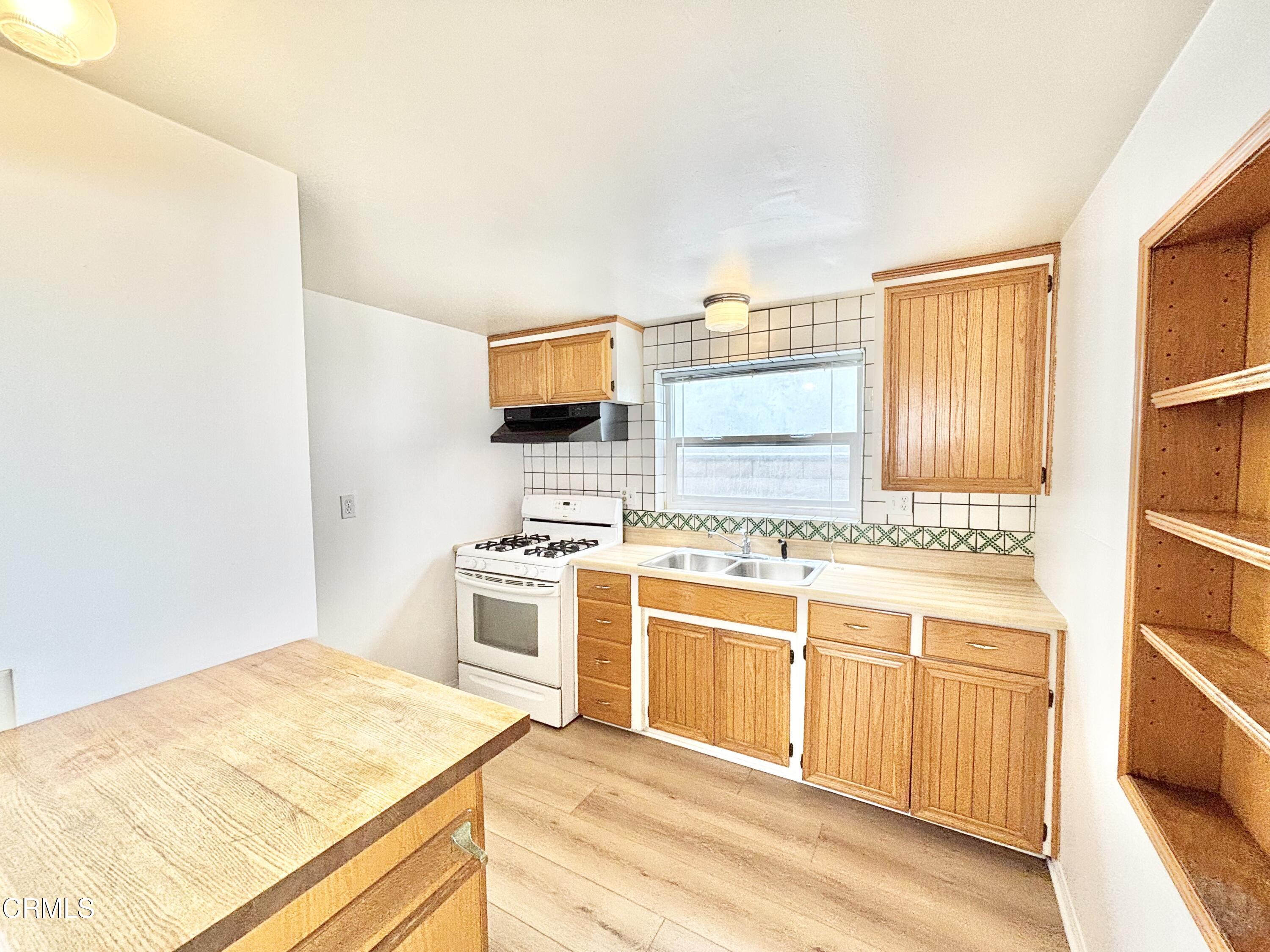 4029 Ocean Drive Oxnard, CA 93035 - Photo 10 of 20 a kitchen with stainless steel appliances granite countertop a stove and a sink