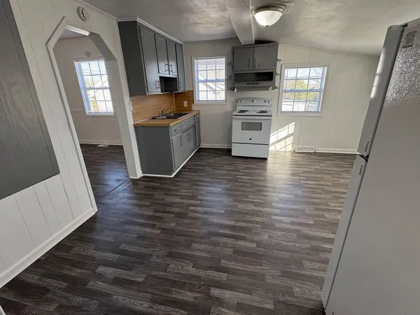 a view of a living room with furniture and flat screen tv