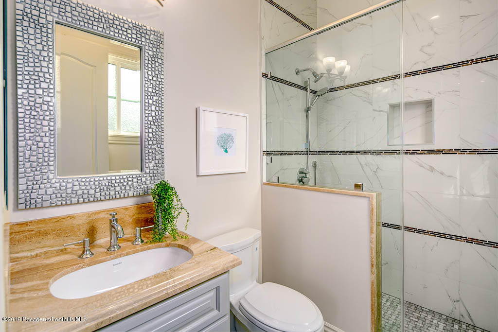 3675 Yorkshire Road Pasadena, CA 91107 - Photo 23 of 32 a bathroom with a sink toilet a mirror and shower
