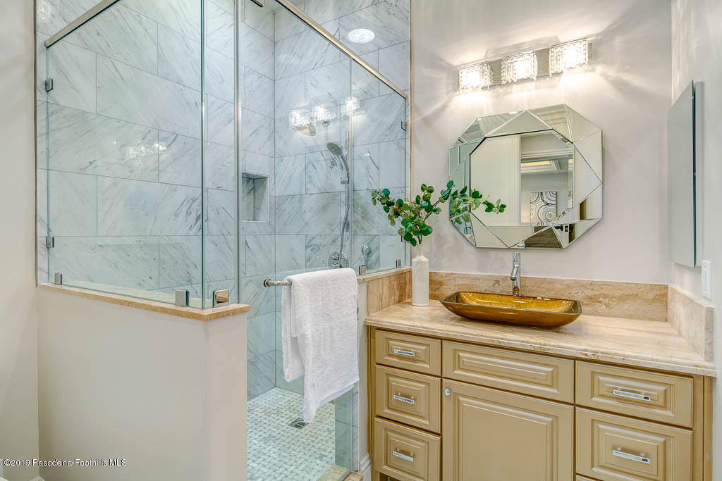 3675 Yorkshire Road Pasadena, CA 91107 - Photo 25 of 32 a bathroom with a sink a mirror and a shower