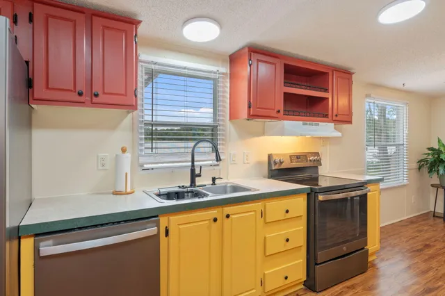 a kitchen with stainless steel appliances granite countertop a sink and cabinets