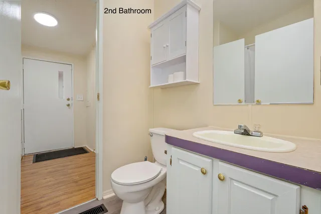 a bathroom with a sink toilet and vanity