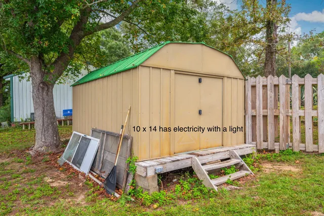 a view of backyard with deck and outdoor seating