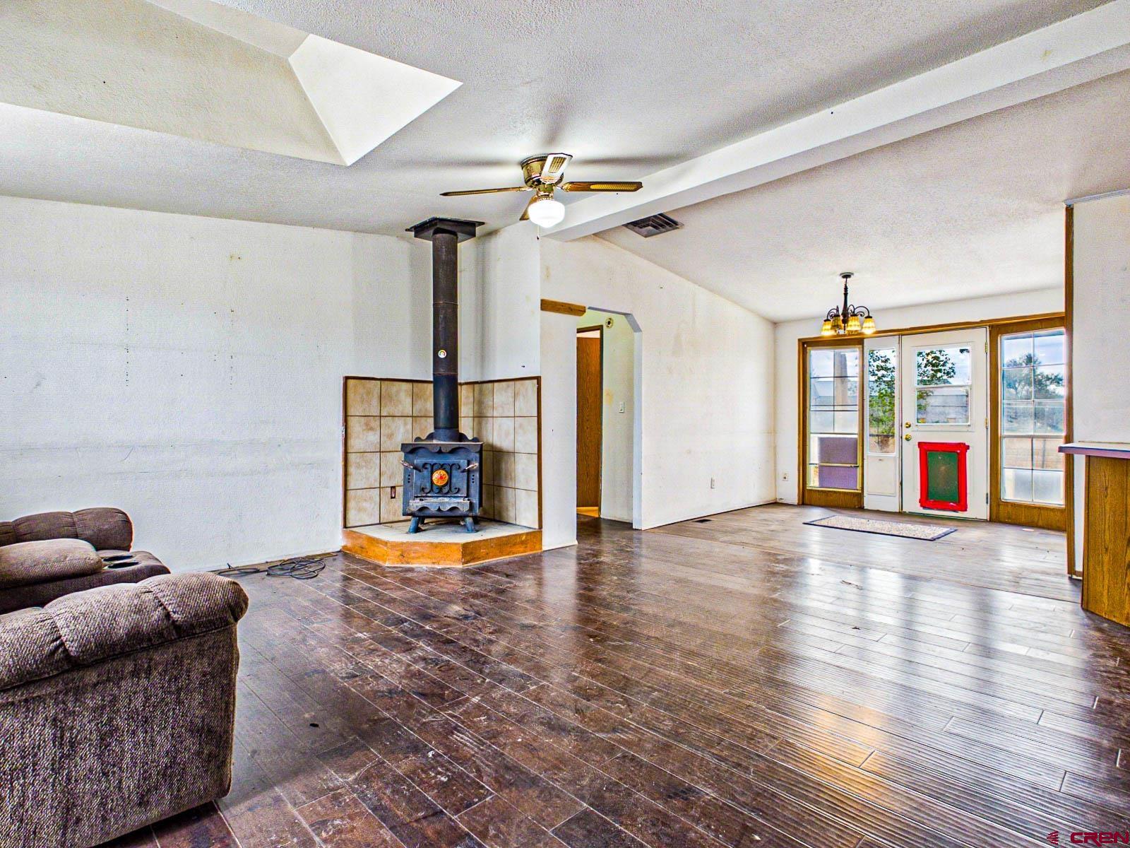 15484 Peach Road Cedaredge, CO 81413 - Photo 7 of 35 a living room with furniture a ceiling fan and a window