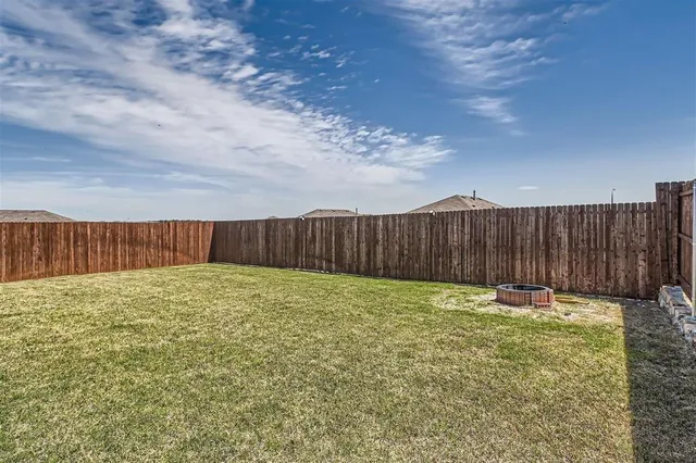 a view of an outdoor space with wooden fence
