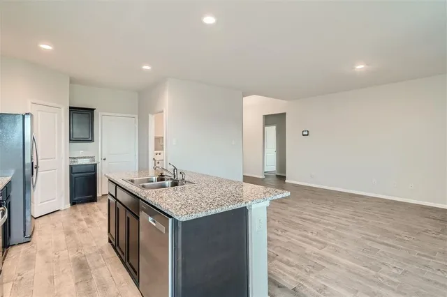 a kitchen with a sink refrigerator and microwave