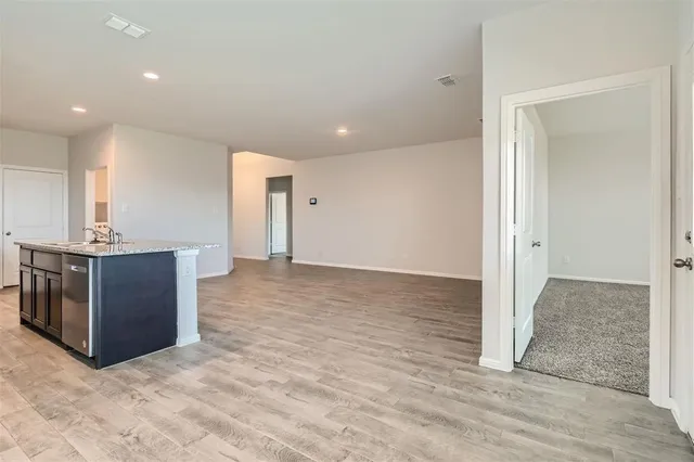 a view of a kitchen with a sink and a refrigerator