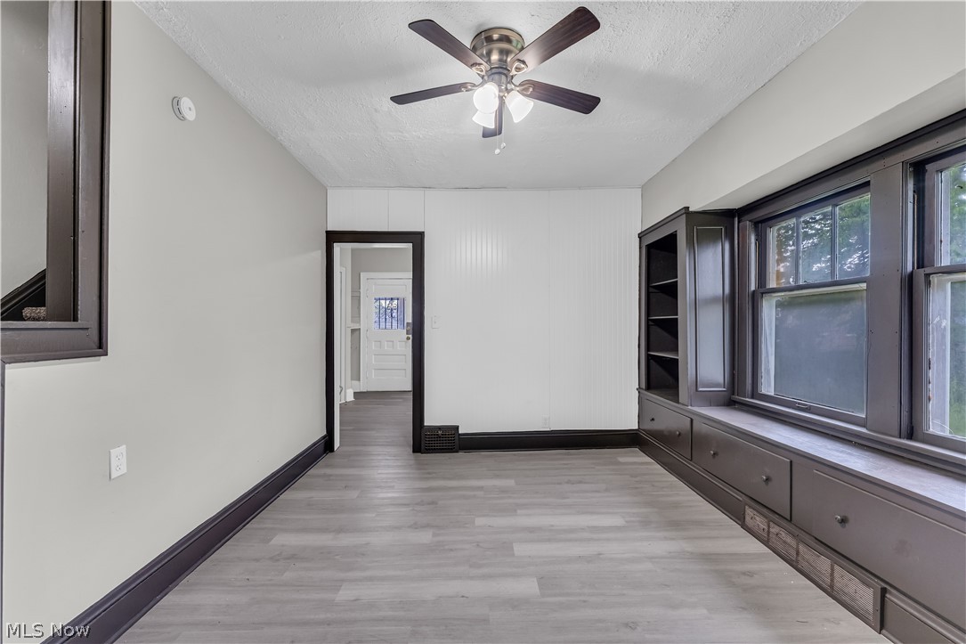 1144 East 145th Street, Unit 1/RIGHT Cleveland, OH 44110 - Photo 7 of 20 Interior space featuring light wood-finish flooring and a ceiling fan