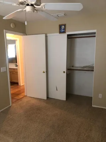 a view of a refrigerator in kitchen and a sink