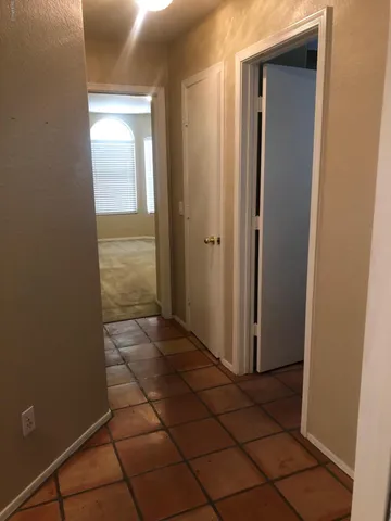 a backyard of a house with table and chairs