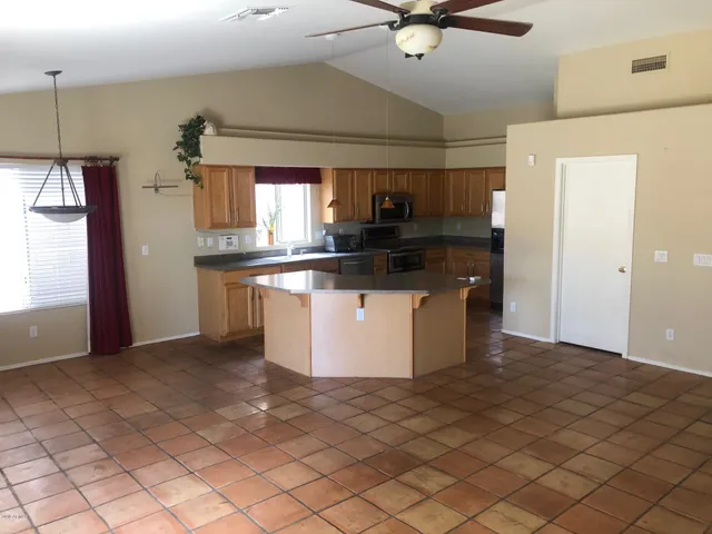 a kitchen with stainless steel appliances granite countertop a refrigerator a sink and a stove