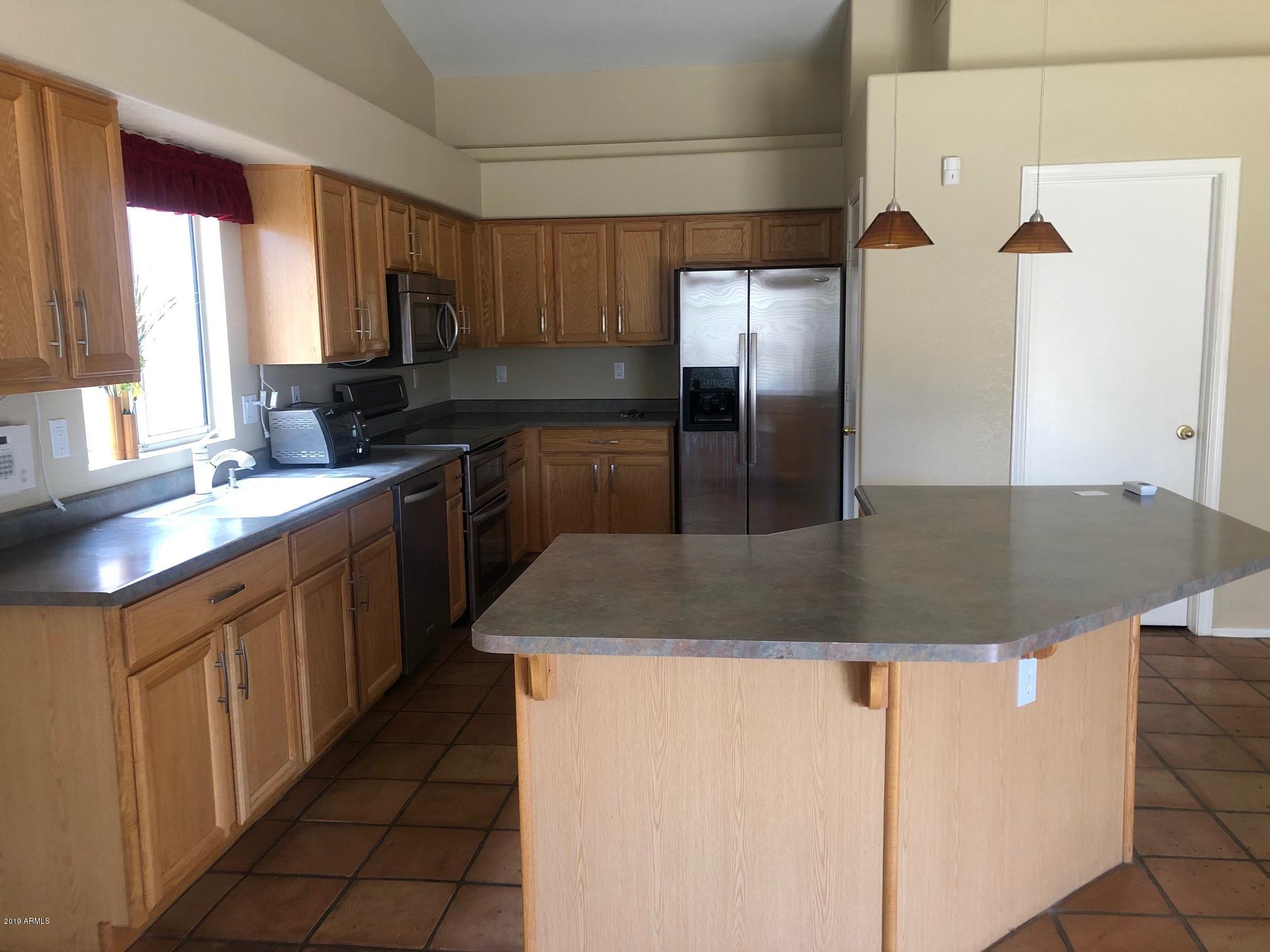 19022 North 24th Place Phoenix, AZ 85050 - Photo 5 of 20 a kitchen with stainless steel appliances granite countertop a sink a microwave a stove and refrigerator