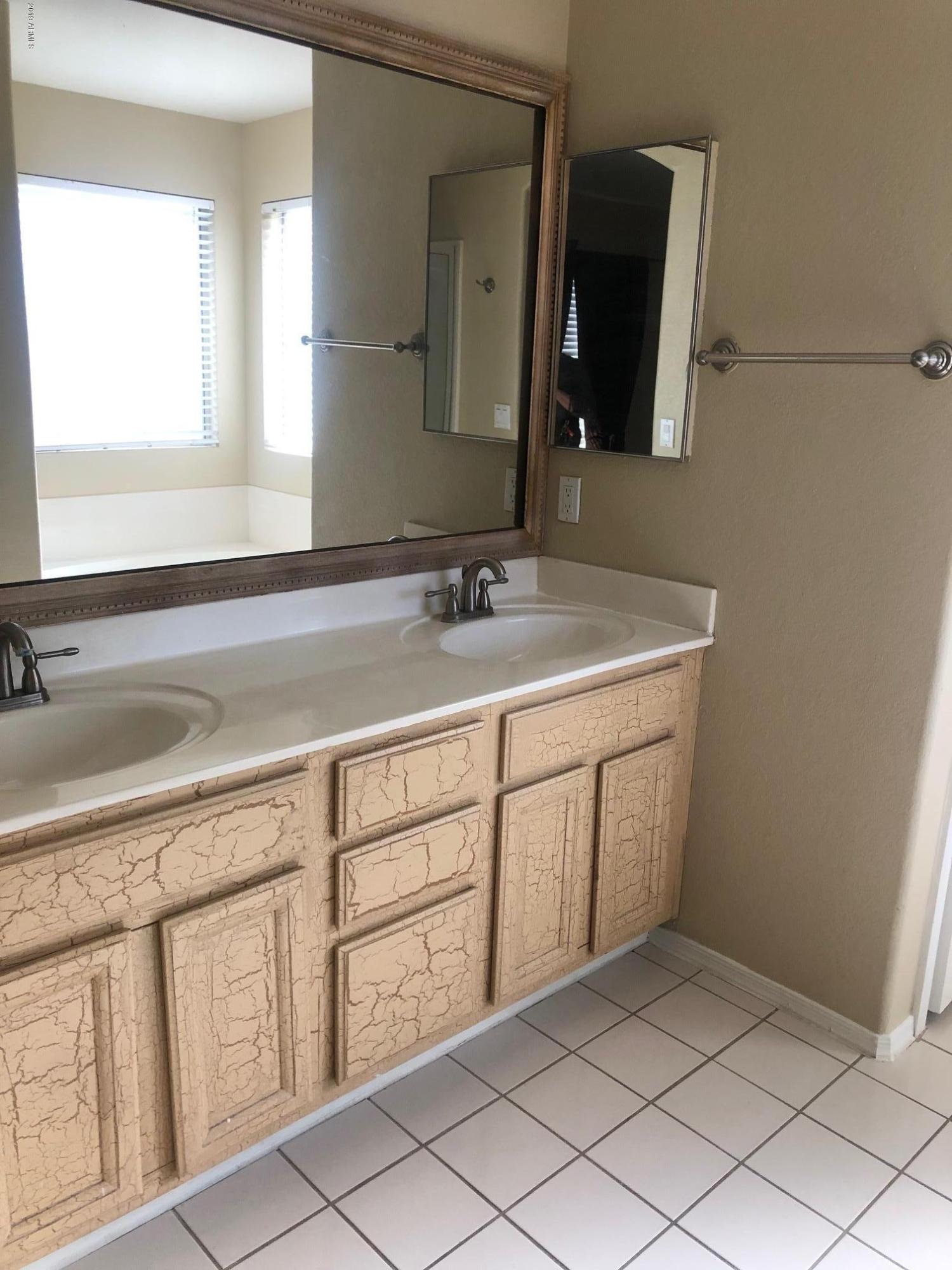 19022 North 24th Place Phoenix, AZ 85050 - Photo 9 of 20 a bathroom with a sink and a mirror