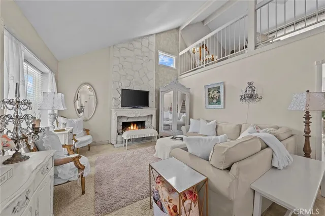 a living room with furniture a clock and a flat screen tv