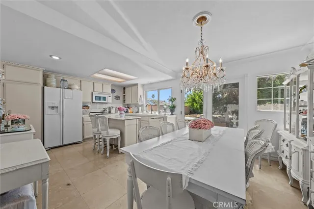 a view of a dining room with furniture and chandelier