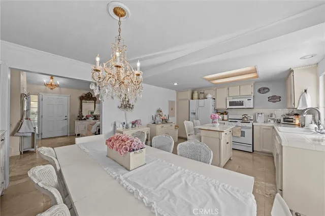 a bedroom with furniture and chandelier