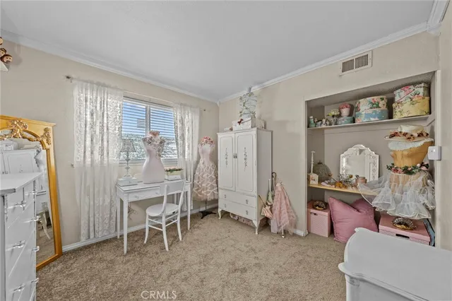 a view of a livingroom with furniture and a fan