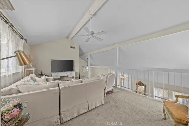 a bedroom with furniture and a flat screen tv