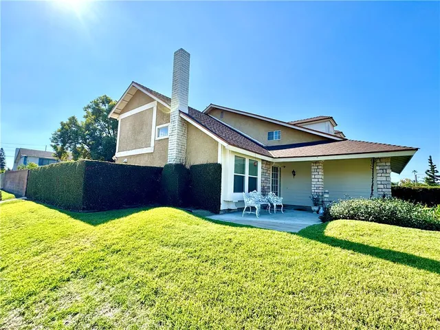 a front view of house with a garden and patio
