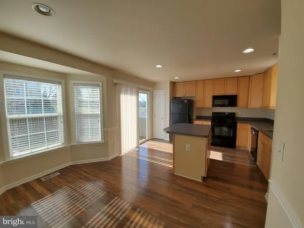a view of kitchen with cabinets and wooden floor