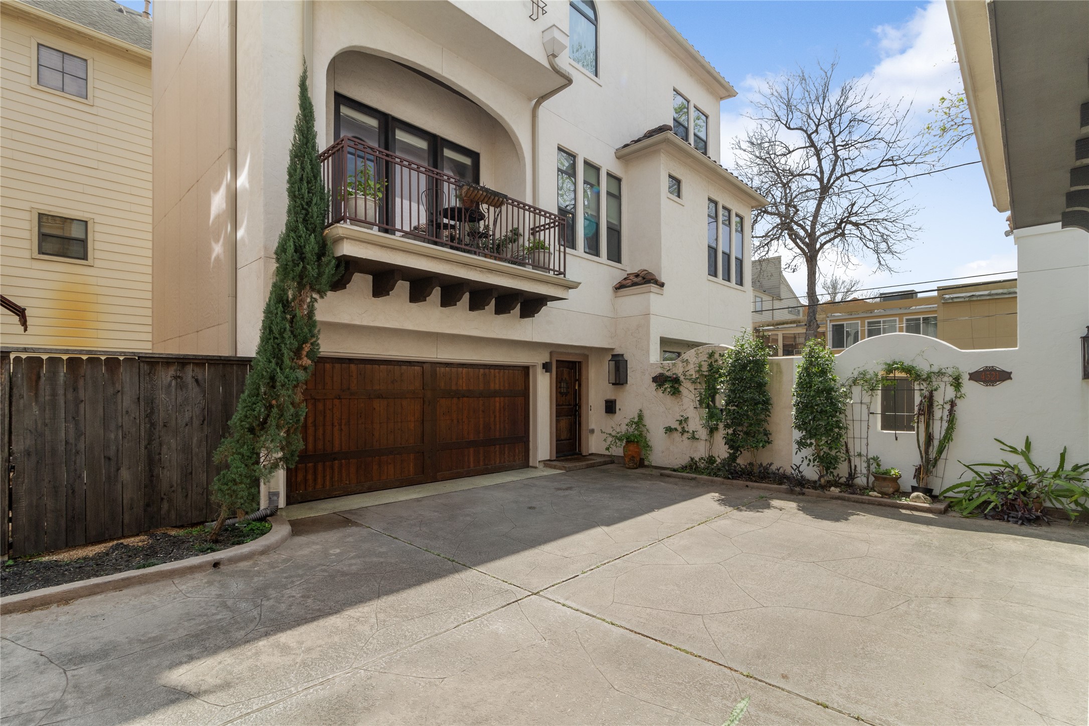 Striking front elevation showcasing Mediterranean design elements, including stucco exterior, clean architectural lines, and ironwork details