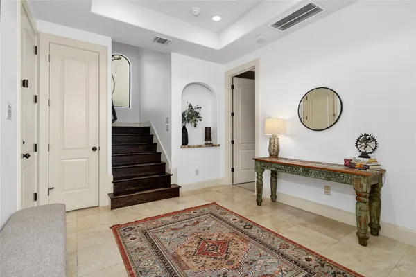 a view of a hallway with entryway wooden floor and front door