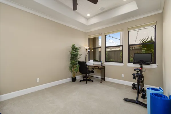 a view of a workspace with furniture and a window