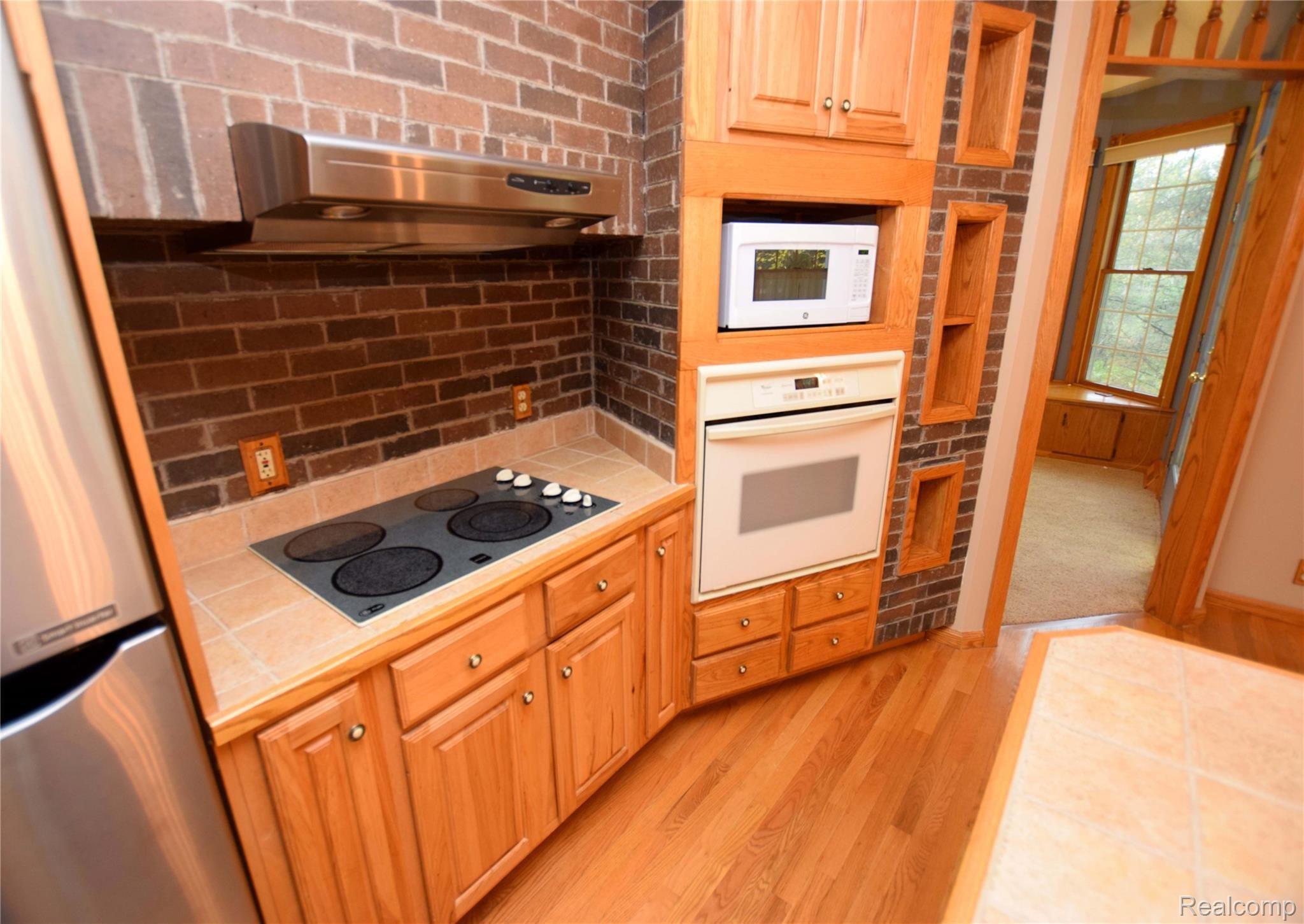 12982 Ithaca Road St. Charles, MI 48655 - Photo 8 of 27 Hickory cabinets abound in your new kitchen