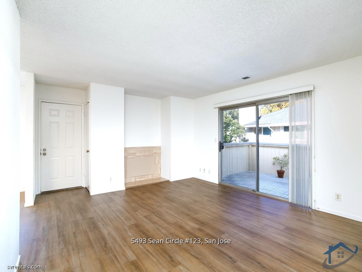 5493 Sean Circle, Unit 123 San Jose, CA 95123 - Photo 4 of 22 an empty room with wooden floor and sliding door
