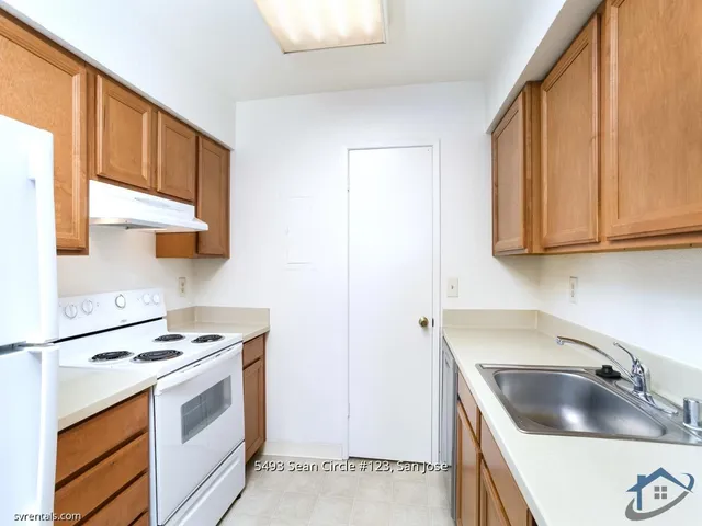 a kitchen with a sink a stove and cabinets