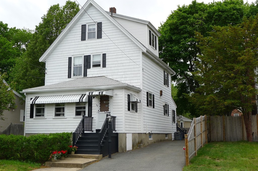 99 Sachem Road Needham, MA 02494 - Photo 1 of 13 a view of a white house with a small yard plants and large tree