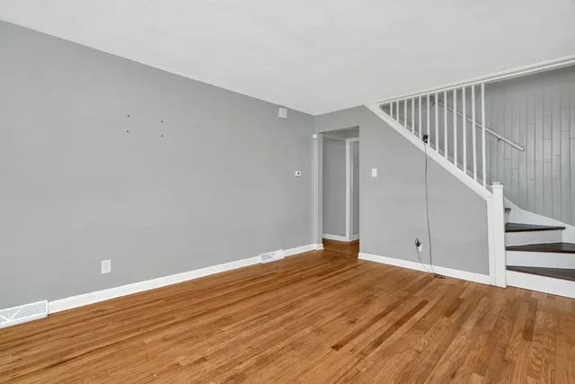 a view of room with wooden floor