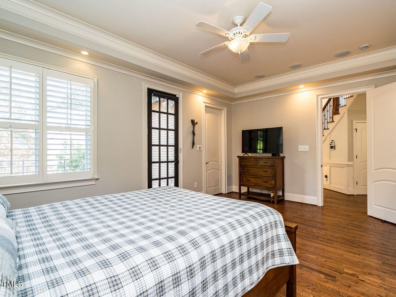 2315 Byrd Street Raleigh, NC 27608 - Photo 19 of 36 a bedroom with a large bed a flat tv screen and a chandelier