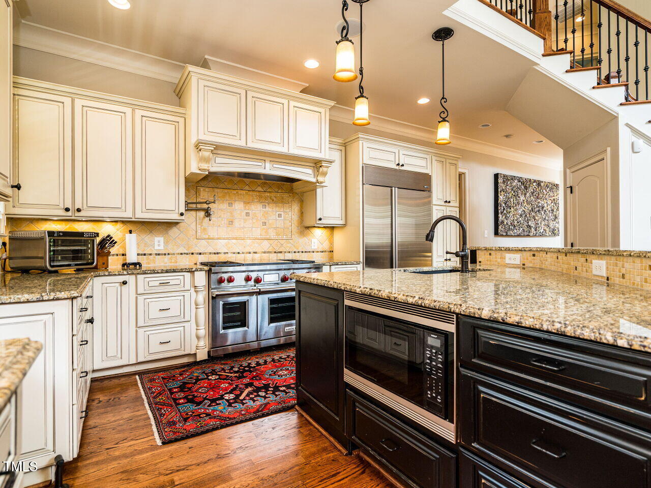 2315 Byrd Street Raleigh, NC 27608 - Photo 10 of 36 a kitchen with stainless steel appliances granite countertop a sink a stove and cabinets