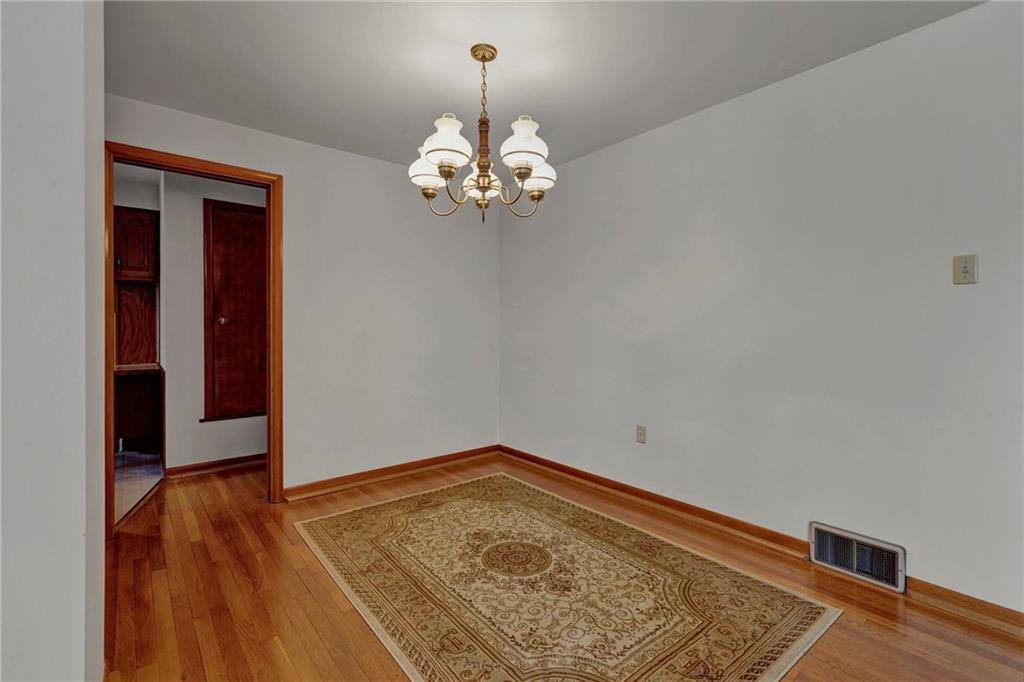 1256 Blaine Road Monaca, PA 15061 - Photo 5 of 23 Dining area open to the living room, with original hardwood flooring.