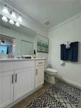 a bathroom with a toilet a sink and a mirror