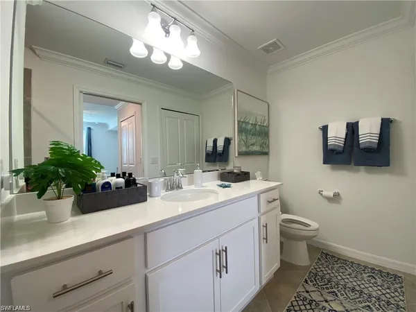 a bathroom with a sink a large mirror and toilet