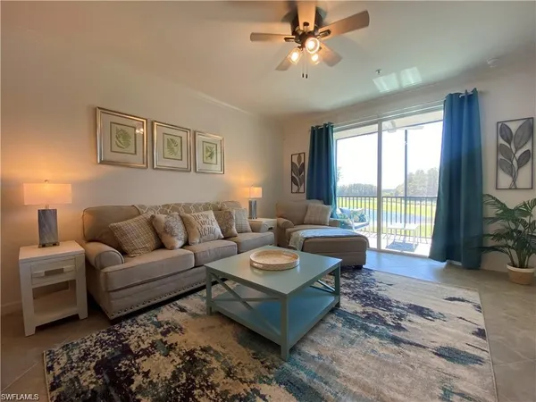 a living room with furniture and a large window