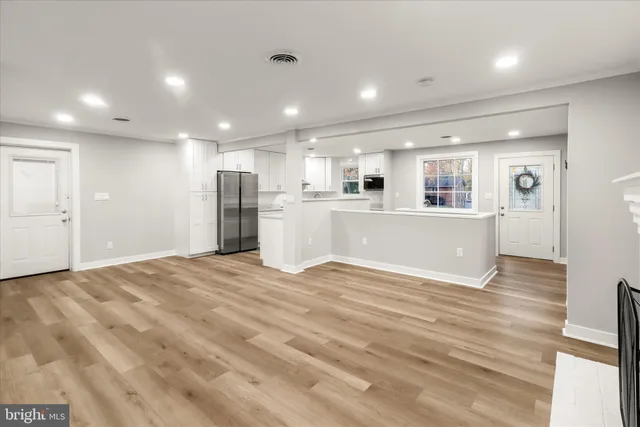 a kitchen with granite countertop white cabinets and stainless steel appliances