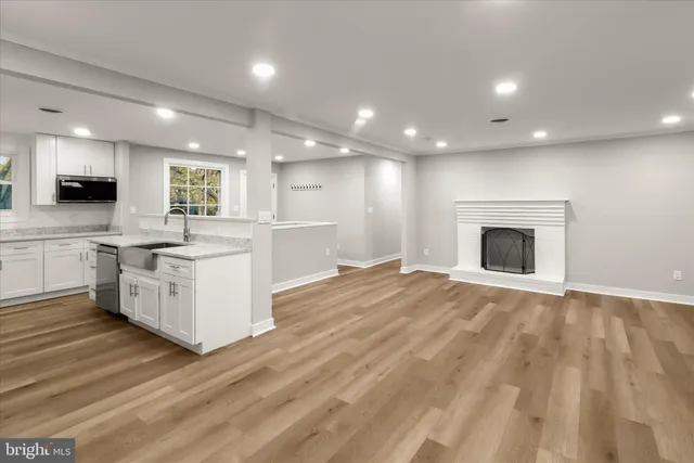 a large kitchen with kitchen island a sink stainless steel appliances and cabinets