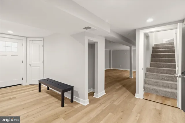 a view of a room with wooden floor and windows