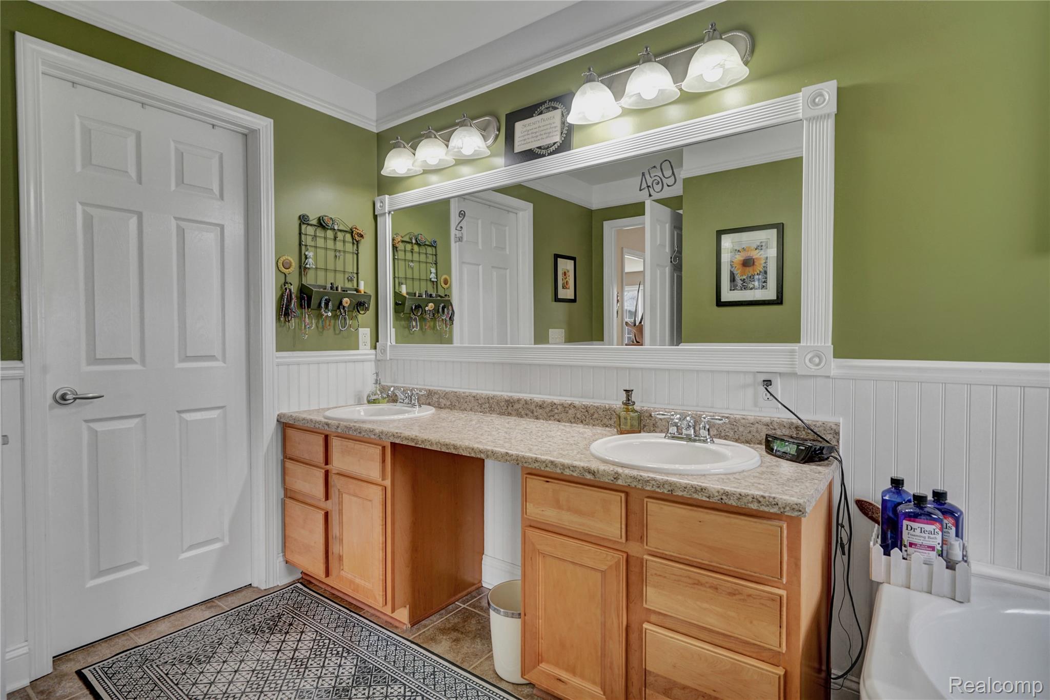 3690 Brauer Road Oxford, MI 48371 - Photo 27 of 63 Bathroom featuring wainscoting, double vanity, a bath, and crown molding