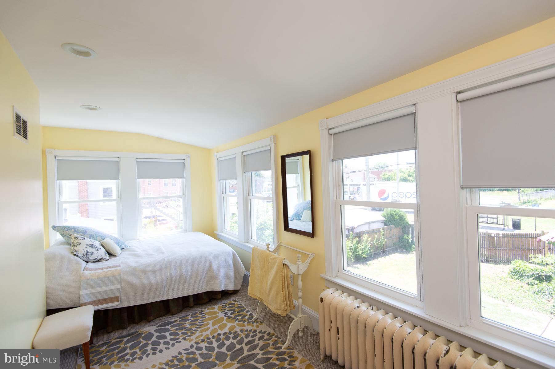 606 Locust Street Cambridge, MD 21613 - Photo 25 of 37 a bedroom with a bed and a couch