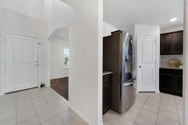 a kitchen with a refrigerator and a stove top oven